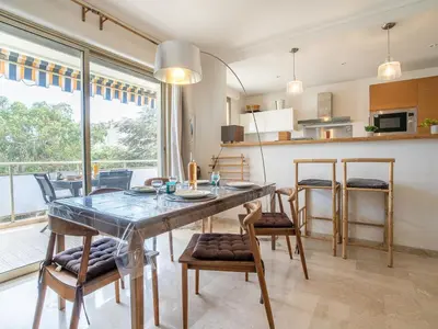 a kitchen and dining room with a table and chairs at Apartment Les Aliscamps by Interhome in Cannes