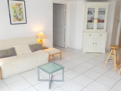 a living room with a couch and a table at Apartment Cannes Bay-2 by Interhome in Cannes