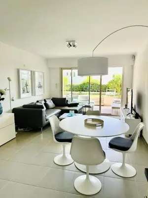 a living room with a white table and chairs at Résidence PARADIS BLEU - Appt 3P in Cannes
