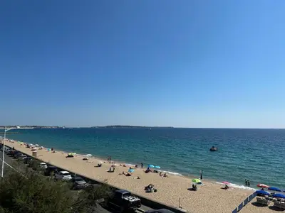 a group of people on a beach with the ocean at Résidence PARADIS BLEU - Appt 3P in Cannes