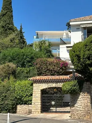 a stone building with a sign for a bar yard at Résidence PARADIS BLEU - Appt 3P in Cannes