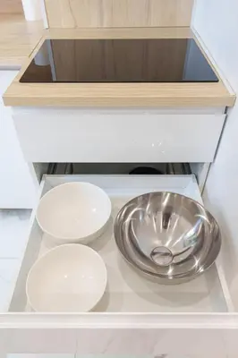 a kitchen with a bowl and two plates on a shelf at Le Maubourg - Hypercentre - 150m Croisette - AC in Cannes