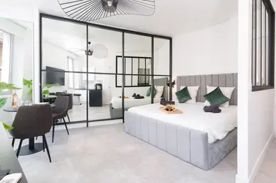 a bedroom with a bed and a dining room at Le Joffre - Hypercentre - 200m Palais - AC in Cannes