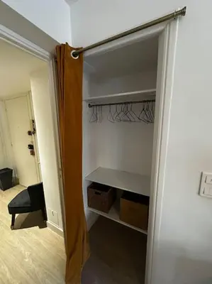 a closet with a door open to a room at Joli F2, 7 min de la gare in Cannes