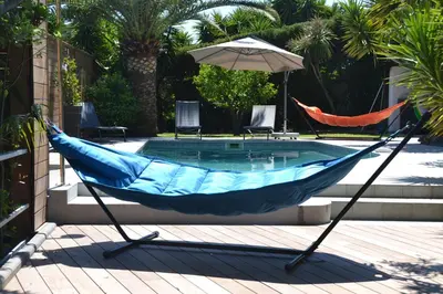 a hammock in front of a swimming pool at CANNES VILLA: 15 mins walk to beach & centre in Cannes