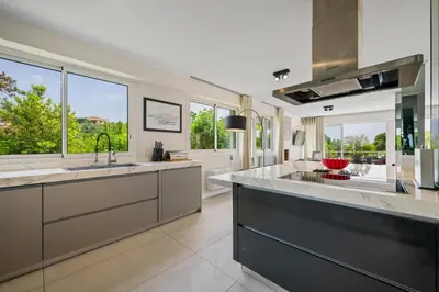 a large kitchen with a large sink and windows at CANNES VILLA: 15 mins walk to beach & centre in Cannes