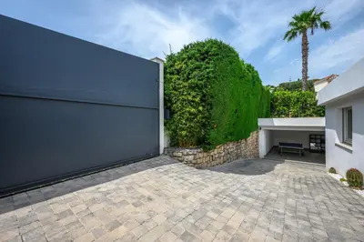 a pivot gate in a driveway of a house at CANNES VILLA: 15 mins walk to beach & centre in Cannes