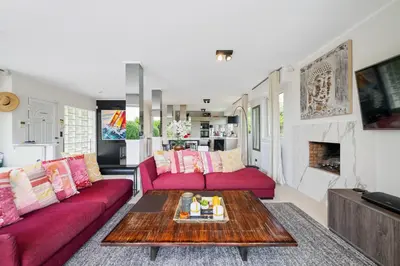 a living room with red couches and a coffee table at CANNES VILLA: 15 mins walk to beach & centre in Cannes
