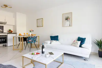 a living room with a white couch and a table at Fleury Home YourHostHelper in Cannes