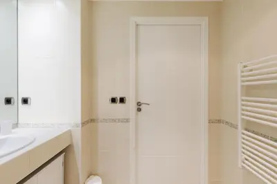 a white bathroom with a shower and a sink at Fleury Home YourHostHelper in Cannes