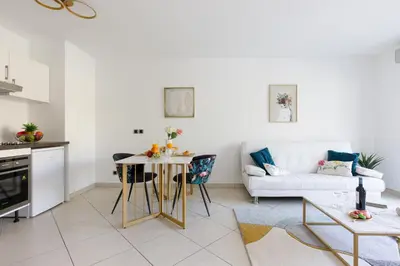 a living room with a table and a couch at Fleury Home YourHostHelper in Cannes