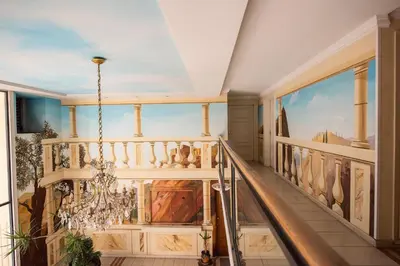 a staircase in a house with a painting on the wall at Palazzio T3 design près des plages et du Palais in Cannes