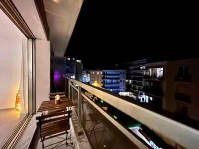 a balcony with a view of a city at night at Appartement Cannes 1 chambre - QG in Cannes