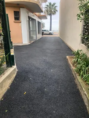 an empty driveway in front of a building at Only 60m to the beach, 2 bedroom cozy apartment, 80m2 big garden, very central in Cannes