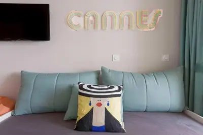 a pillow sitting on a couch in a room at Bella Vista - Piscine, vue mer, parking, clim in Cannes