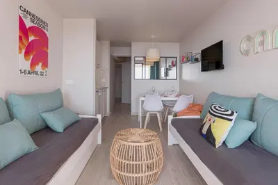 a living room with two blue couches and a table at Bella Vista - Piscine, vue mer, parking, clim in Cannes