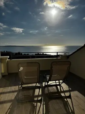 two chairs sitting on a balcony looking at the ocean at Villa Francia Cannes in Cannes