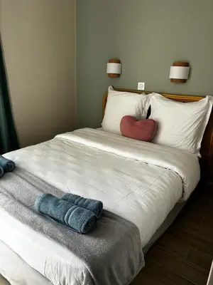 a bed with two pillows and a heart on it at Villa Francia Cannes in Cannes