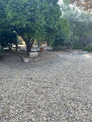 a park with a bench and a tree and gravel at Chez Nicole in Cannes