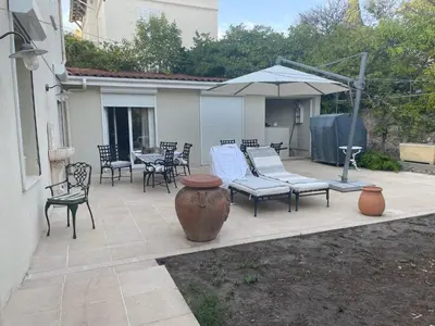 a patio with a table and chairs and an umbrella at Chez Nicole in Cannes