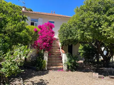 a house with a staircase with pink flowers at Chez Nicole in Cannes