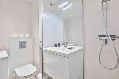 a white bathroom with a shower and a toilet at Superbe studio avec terrasse à 10 min de la plage in Cannes