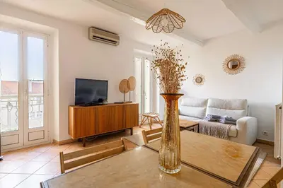 a living room with a vase on a table at Charming apartment heart of Le Suquet in Cannes