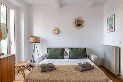 a bedroom with a bed with towels on it at Charming apartment heart of Le Suquet in Cannes