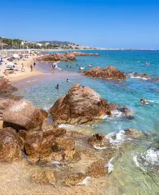a group of people on a beach with rocks at Appartement 3 pièces, proche plage et cannes in Cannes