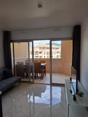 a living room with a couch and a table at Appartement 3 pièces, proche plage et cannes in Cannes