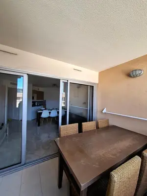 a dining room with a table and chairs at Appartement 3 pièces, proche plage et cannes in Cannes
