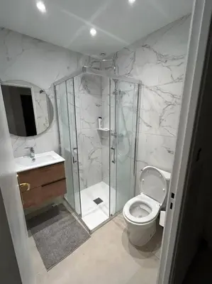 a bathroom with a shower and a toilet and a sink at Appartement Veronica in Cannes