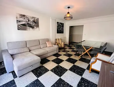 a living room with a couch and a glass table at Appartement Veronica in Cannes