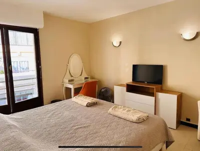 a bedroom with a bed and a flat screen tv at Appartement Veronica in Cannes