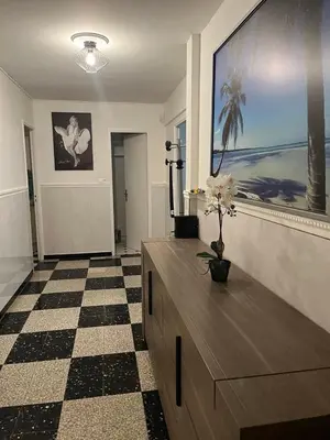 a living room with a large television and a dresser at Appartement Veronica in Cannes