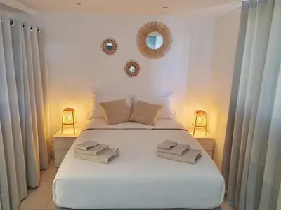 a bedroom with a white bed with two towels on it at Studio hyper centre Cannes - Tout à pied in Cannes
