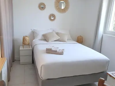 a bedroom with a white bed with towels on it at Studio hyper centre Cannes - Tout à pied in Cannes