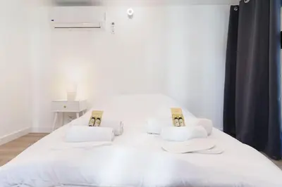 a white bed with white pillows on it at Le Val By ApiRent #Duplex #Climatisation in Le Cannet