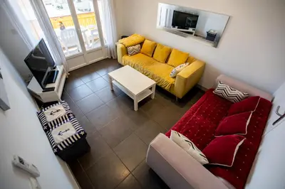 a living room with a couch and a tv at Comfort 6 People Apartment by Connexion in Cannes