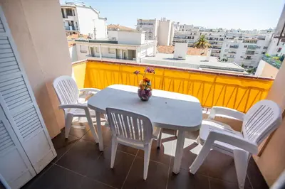 a table and chairs on a balcony with a view at Comfort 6 People Apartment by Connexion in Cannes