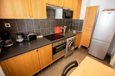 a kitchen with a sink and a refrigerator at Comfort 6 People Apartment by Connexion in Cannes