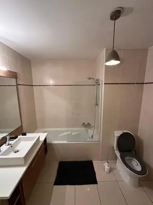 a bathroom with a tub and a toilet and a sink at Les Jardins de Louis in Cannes