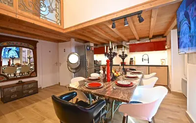 a dining room with a table and white chairs at DUPLEX 6 chambres Clim WIFI SAUNA Cannes in Cannes