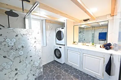 a bathroom with a washing machine and a sink at DUPLEX 6 chambres Clim WIFI SAUNA Cannes in Cannes