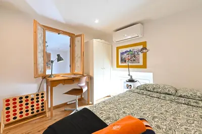 a bedroom with a bed and a desk with a computer at DUPLEX 6 chambres Clim WIFI SAUNA Cannes in Cannes