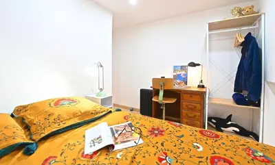 a bedroom with a bed with a book on it at DUPLEX 6 chambres Clim WIFI SAUNA Cannes in Cannes