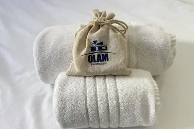 a stack of towels with a bag on top at 2 pièces balcon 4 pers Meynadier Palais 1 minute by Olam Properties in Cannes