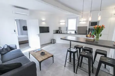 a kitchen and living room with a couch and a table at 2 pièces balcon 4 pers Meynadier Palais 1 minute by Olam Properties in Cannes