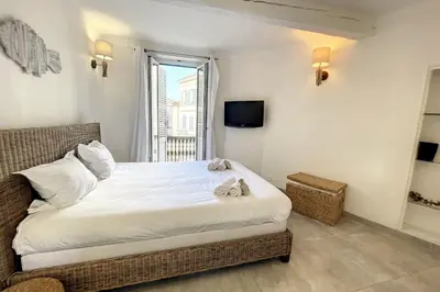 a bedroom with a bed with a television and a window at 2 pièces balcon 4 pers Meynadier Palais 1 minute by Olam Properties in Cannes