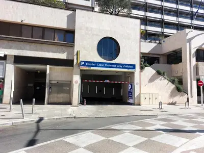 a building with a parking garage in a city at Gray d'Albion - Cannes Rue d'Antibes - 2 Minutes walk from Beach, Palais des Festivals, Boulevard de la Croisette - Free Parking in Cannes